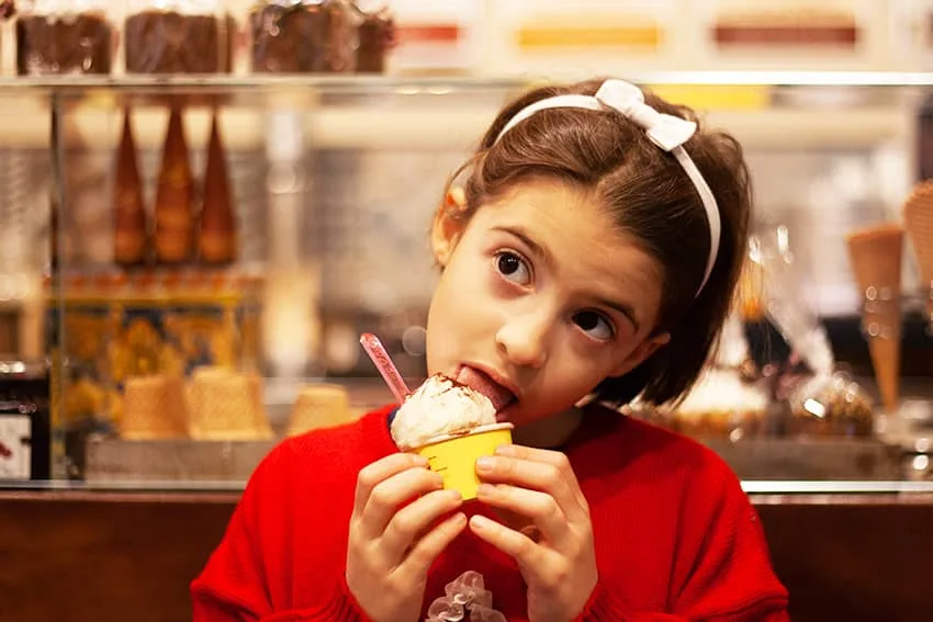 Child enjoying gelato in a Bologna gelateria