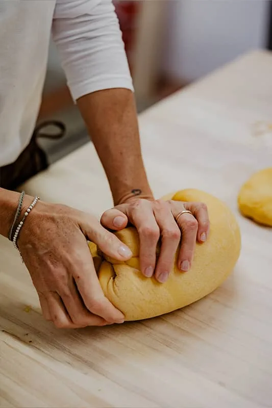 Hands working fresh pasta dough